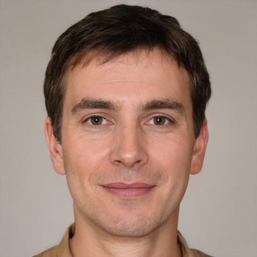 Joyful white adult male with short  brown hair and brown eyes