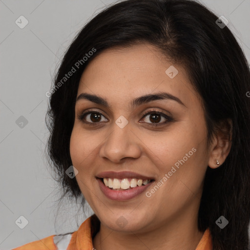 Joyful latino young-adult female with long  brown hair and brown eyes