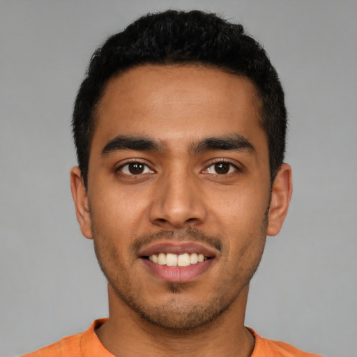 Joyful latino young-adult male with short  brown hair and brown eyes