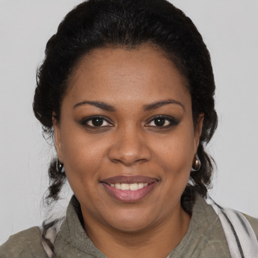 Joyful black young-adult female with short  brown hair and brown eyes