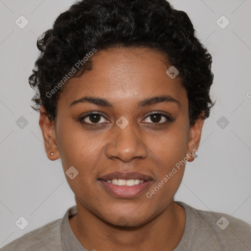 Joyful black young-adult female with short  black hair and brown eyes