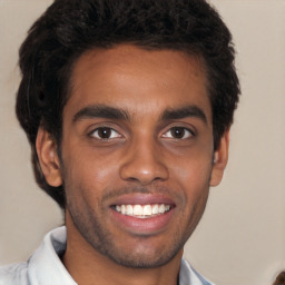 Joyful black young-adult male with short  black hair and brown eyes