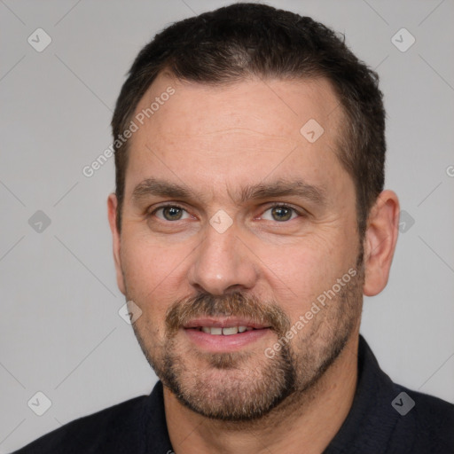 Joyful white adult male with short  brown hair and brown eyes