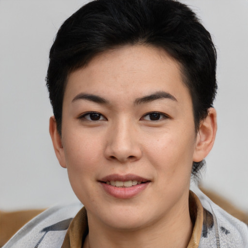 Joyful asian young-adult female with short  brown hair and brown eyes