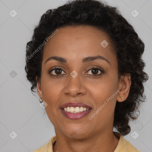 Joyful black adult female with medium  brown hair and brown eyes