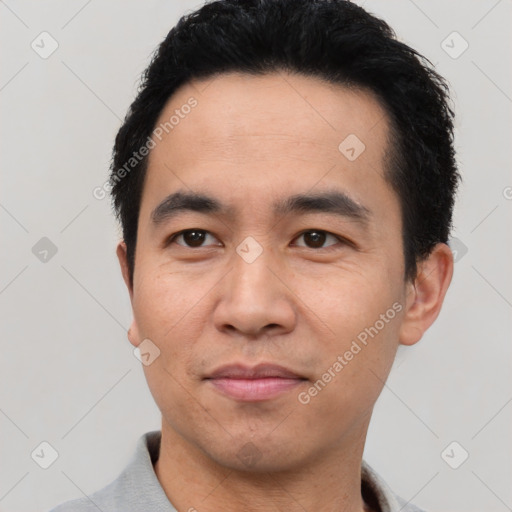 Joyful white young-adult male with short  black hair and brown eyes