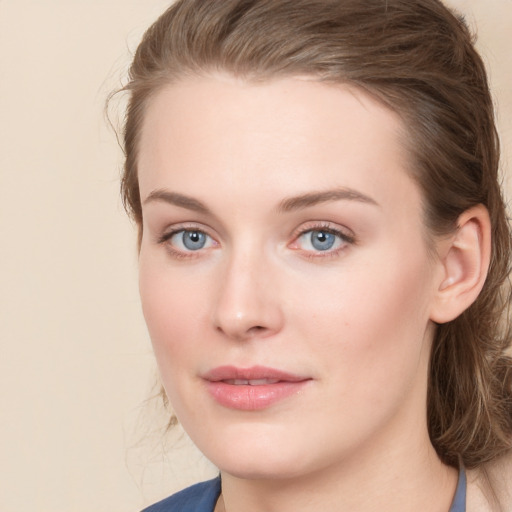 Joyful white young-adult female with long  brown hair and blue eyes