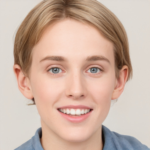 Joyful white young-adult female with short  brown hair and blue eyes