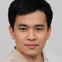 Joyful asian young-adult male with short  brown hair and brown eyes