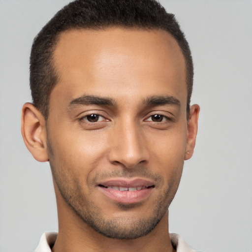 Joyful latino young-adult male with short  brown hair and brown eyes