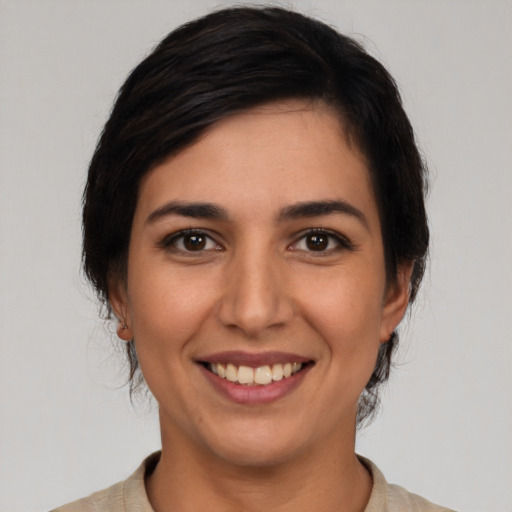 Joyful latino young-adult female with medium  brown hair and brown eyes