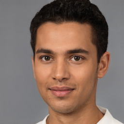 Joyful white young-adult male with short  black hair and brown eyes