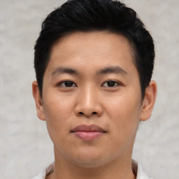 Joyful asian young-adult male with short  black hair and brown eyes