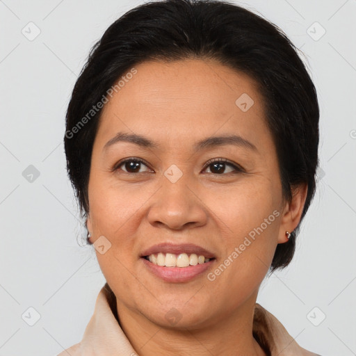 Joyful latino adult female with medium  brown hair and brown eyes