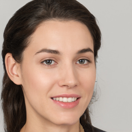 Joyful white young-adult female with medium  brown hair and brown eyes