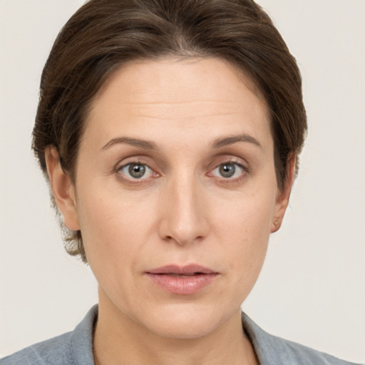 Joyful white adult female with short  brown hair and grey eyes