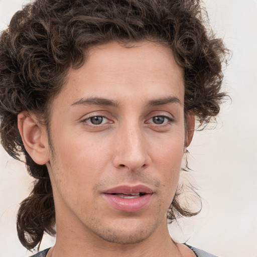 Joyful white young-adult male with medium  brown hair and brown eyes