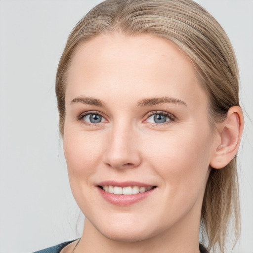 Joyful white young-adult female with medium  brown hair and blue eyes