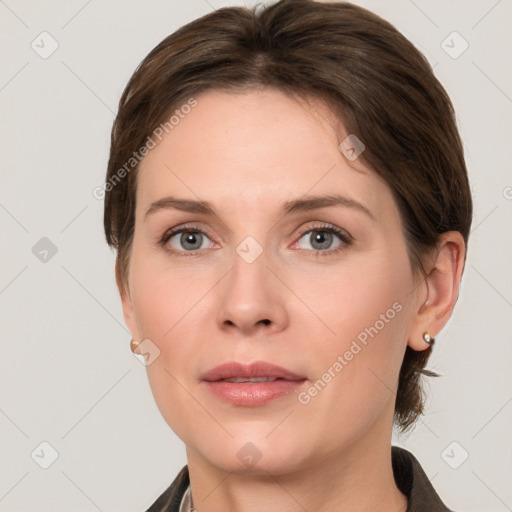 Joyful white young-adult female with medium  brown hair and grey eyes