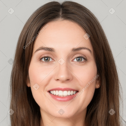 Joyful white young-adult female with long  brown hair and grey eyes