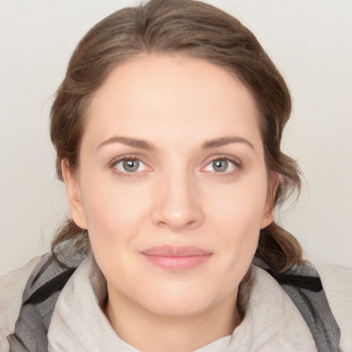 Joyful white young-adult female with medium  brown hair and grey eyes