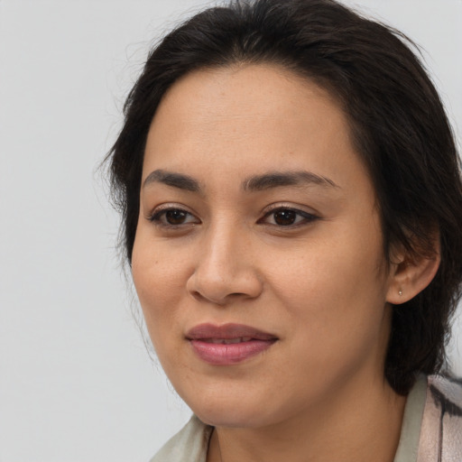 Joyful asian young-adult female with medium  brown hair and brown eyes