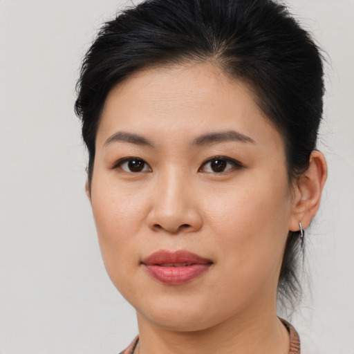 Joyful asian young-adult female with medium  brown hair and brown eyes