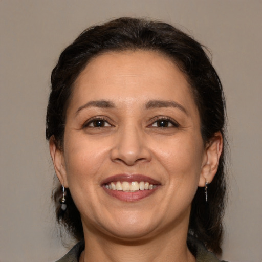 Joyful white adult female with medium  brown hair and brown eyes