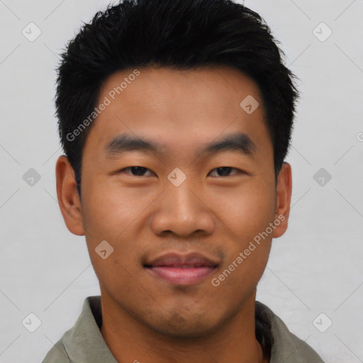 Joyful asian young-adult male with short  black hair and brown eyes