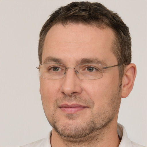 Joyful white adult male with short  brown hair and brown eyes