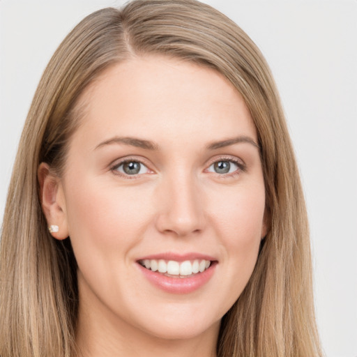 Joyful white young-adult female with long  brown hair and grey eyes