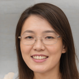 Joyful white adult female with long  brown hair and brown eyes