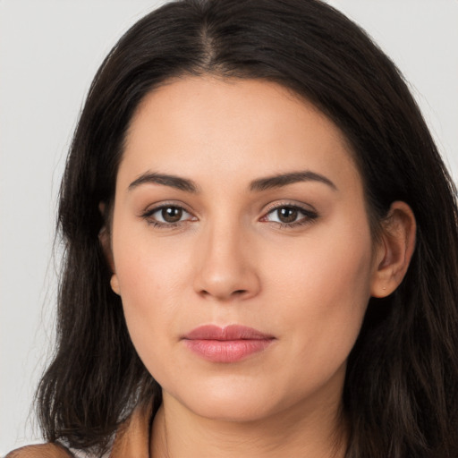 Joyful latino young-adult female with long  brown hair and brown eyes