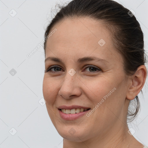 Joyful white adult female with medium  brown hair and brown eyes