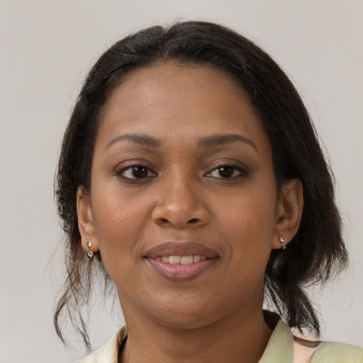 Joyful black young-adult female with medium  brown hair and brown eyes