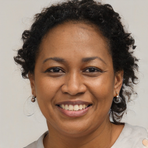 Joyful black adult female with short  brown hair and brown eyes