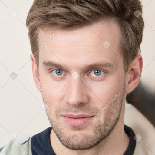 Joyful white young-adult male with short  brown hair and grey eyes