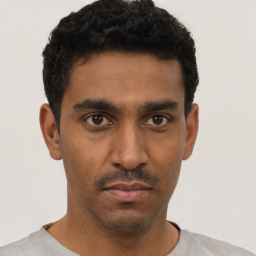 Neutral black young-adult male with short  black hair and brown eyes