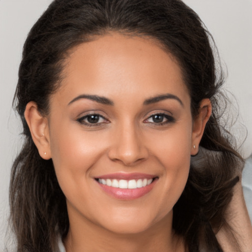 Joyful white young-adult female with long  brown hair and brown eyes