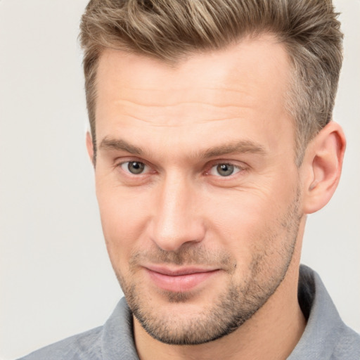 Joyful white adult male with short  brown hair and brown eyes