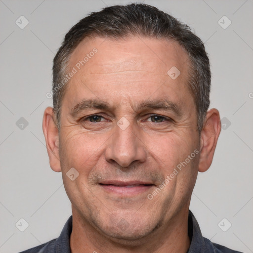 Joyful white adult male with short  brown hair and brown eyes