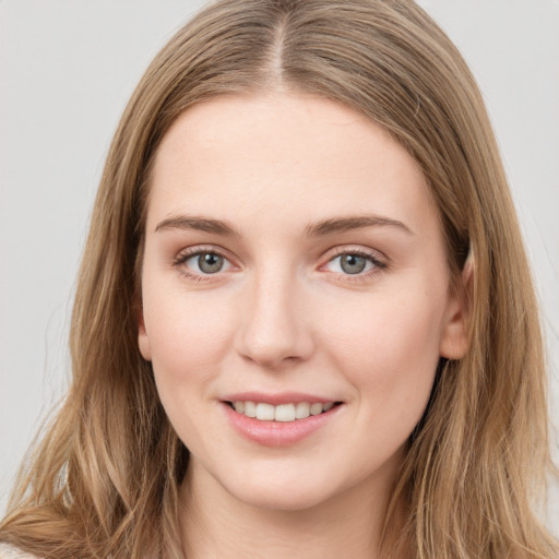 Joyful white young-adult female with long  brown hair and grey eyes