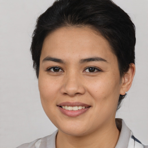 Joyful asian young-adult female with medium  brown hair and brown eyes