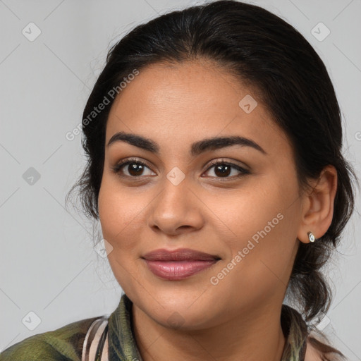 Joyful latino young-adult female with medium  brown hair and brown eyes