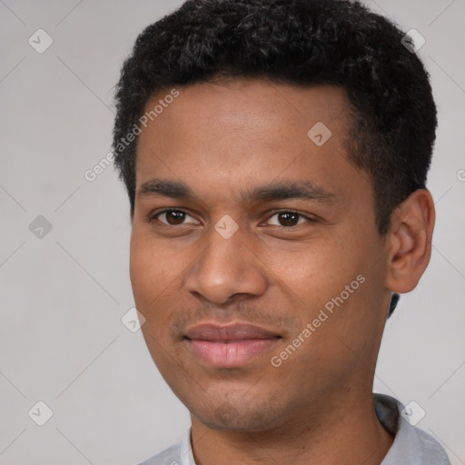 Joyful black young-adult male with short  black hair and brown eyes