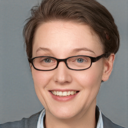 Joyful white adult female with short  brown hair and blue eyes