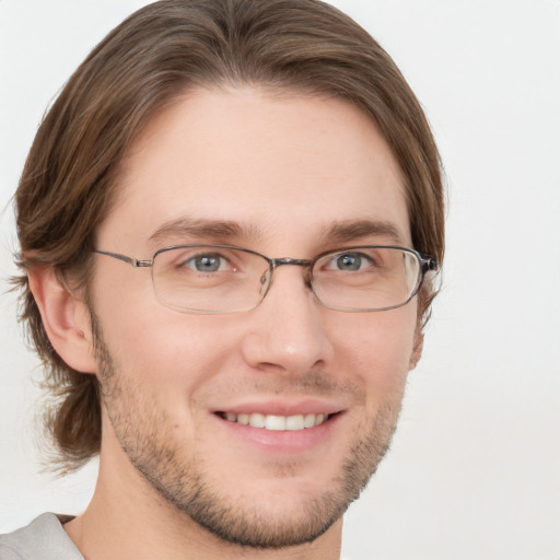 Joyful white adult male with short  brown hair and green eyes