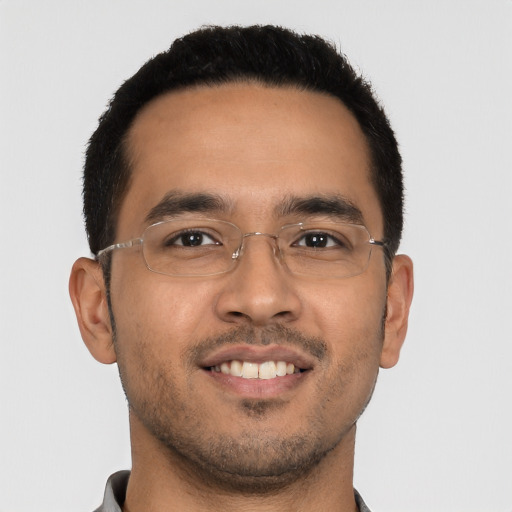 Joyful latino young-adult male with short  black hair and brown eyes