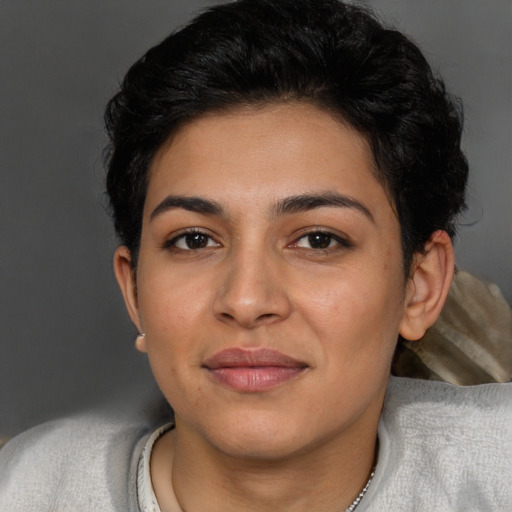 Joyful latino young-adult female with short  brown hair and brown eyes