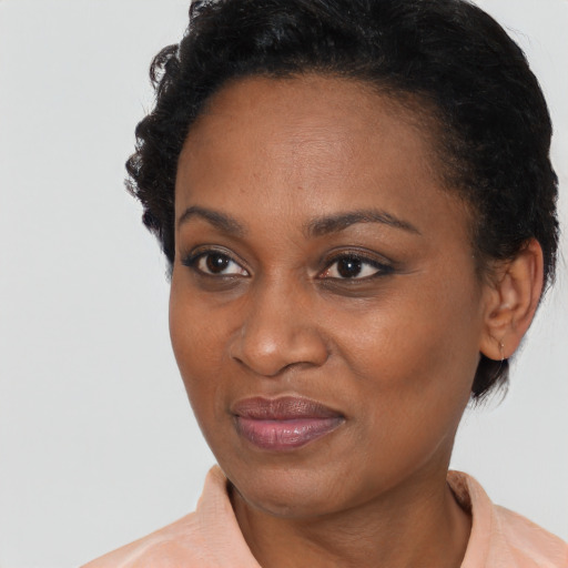 Joyful black adult female with short  brown hair and brown eyes
